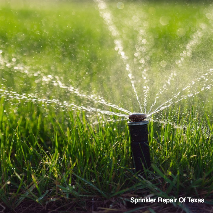automatic sprinkler system watering lawn